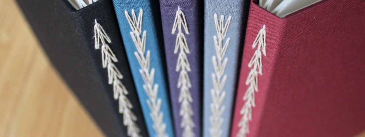 Bindings of 5 colorful books with sewing