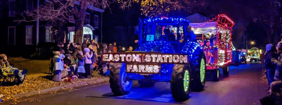 tractor in tractor parade with lights that spell out easton station farms