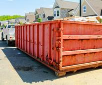 dumpster in front of a house