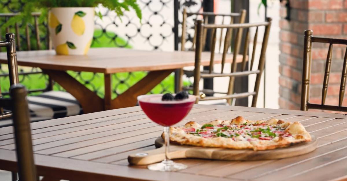 patio dining with pizza and cocktail