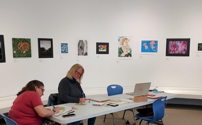 Participants writing at The Hyde Collection